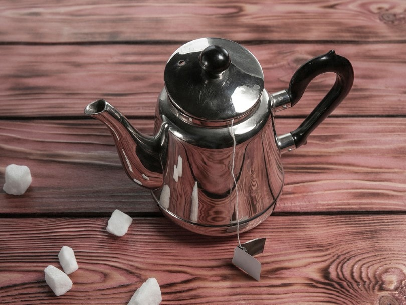 咖啡壶和白糖在木制背景